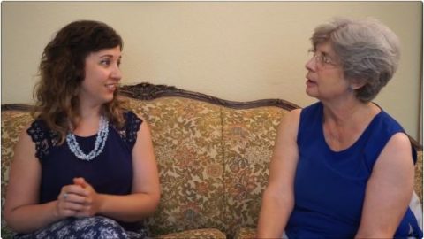 Two women talking on a sofa