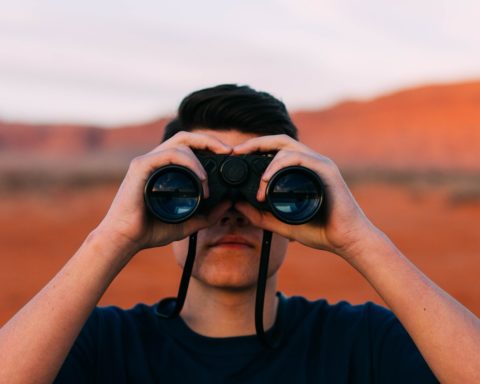 Man in the desert with binoculars