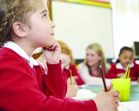 Girl in a classroom listening attentively