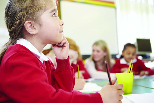 Girl in a classroom listening attentively